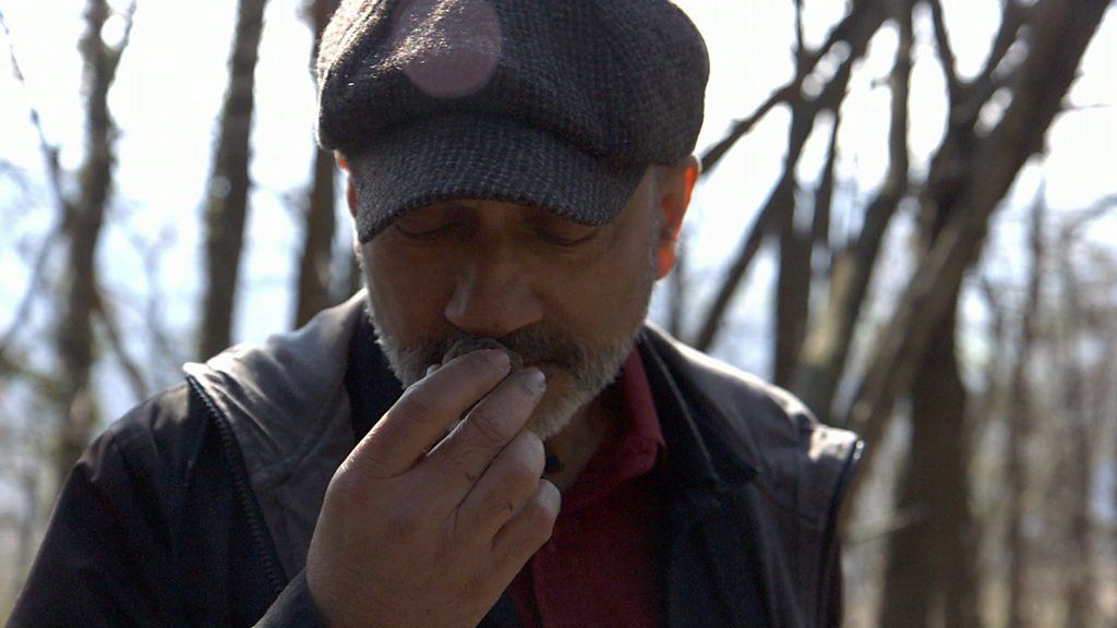 Rajan Datar smells a truffle in woodland in Italy's Piedmont region