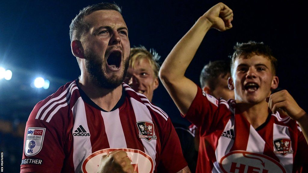 Pierce Sweeney celebrates scoring the winning penalty as Exeter City progressed in the Carabao Cup