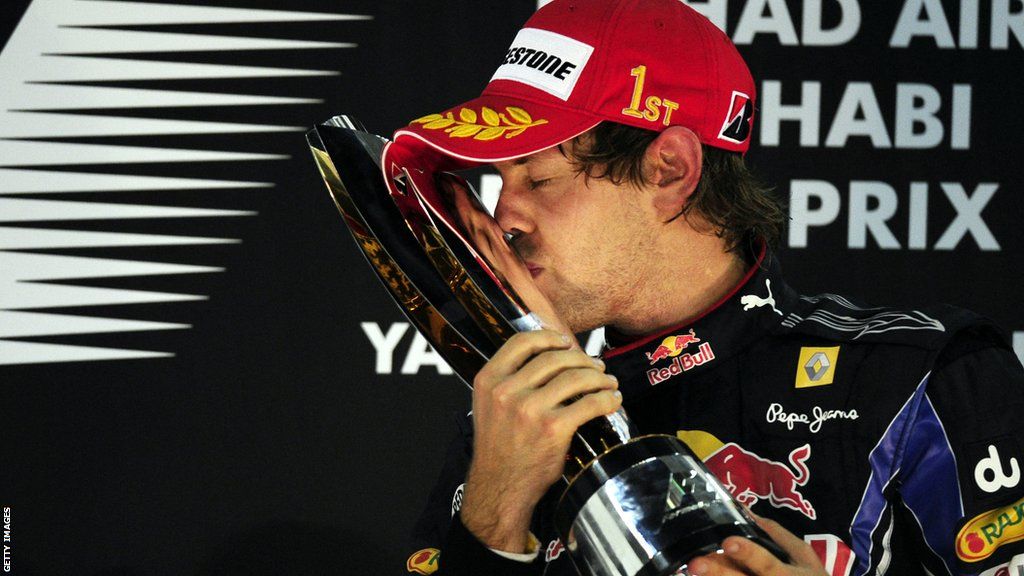 Sebastian Vettel kisses the Formula 1 drivers' world championship trophy in 2010