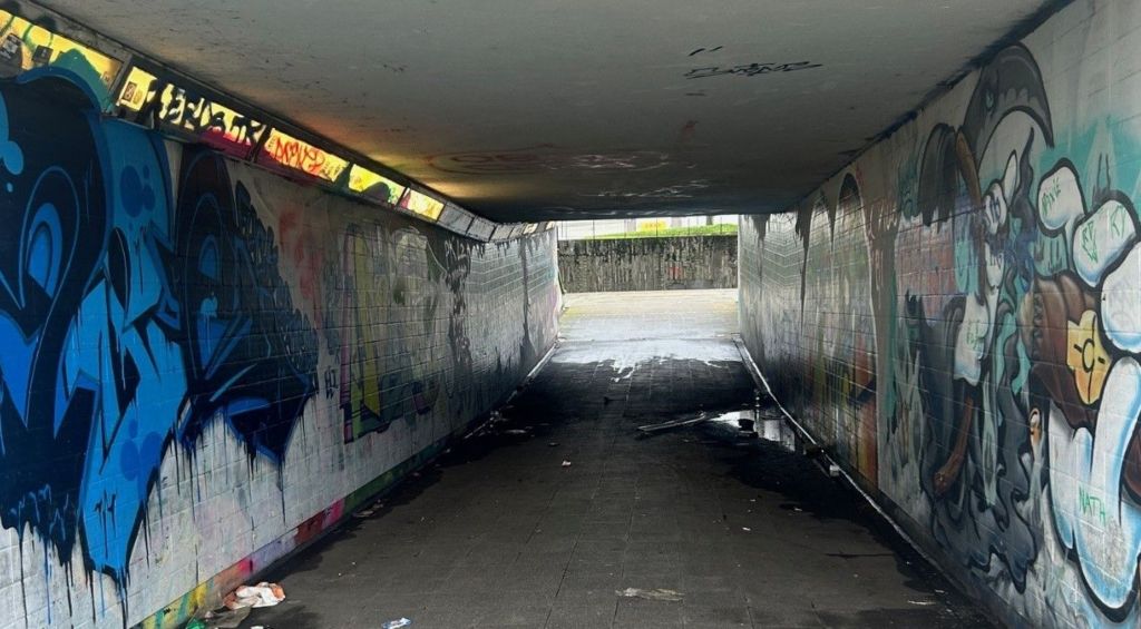 An underpass covered in graffiti
