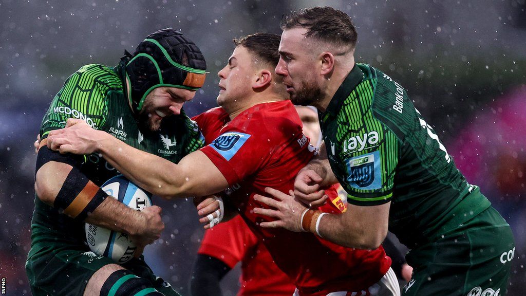 Munster's Shamus Hurley-Langton is tackled by Tony Butler with JJ Hanrahan also in attendance
