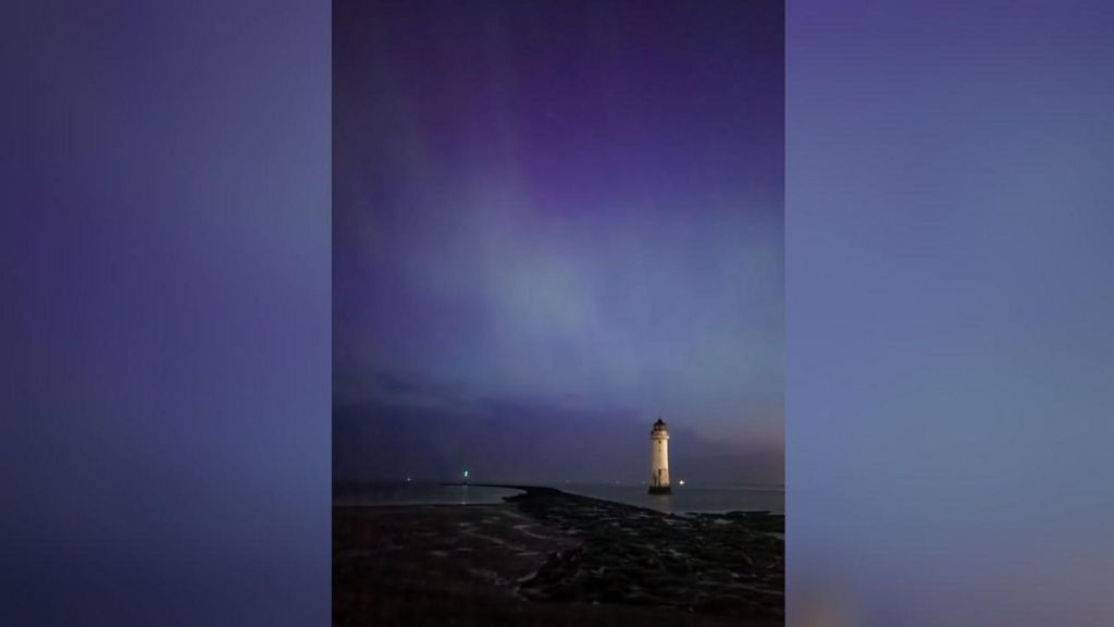 The Northern Lights seen from New Brighton in Wirral, with a view of the lighthouse