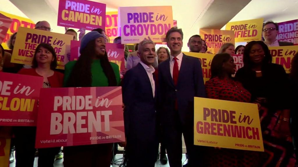 A group of Labour politicians holding up signs that say Pride In and the names of various London boroughs.