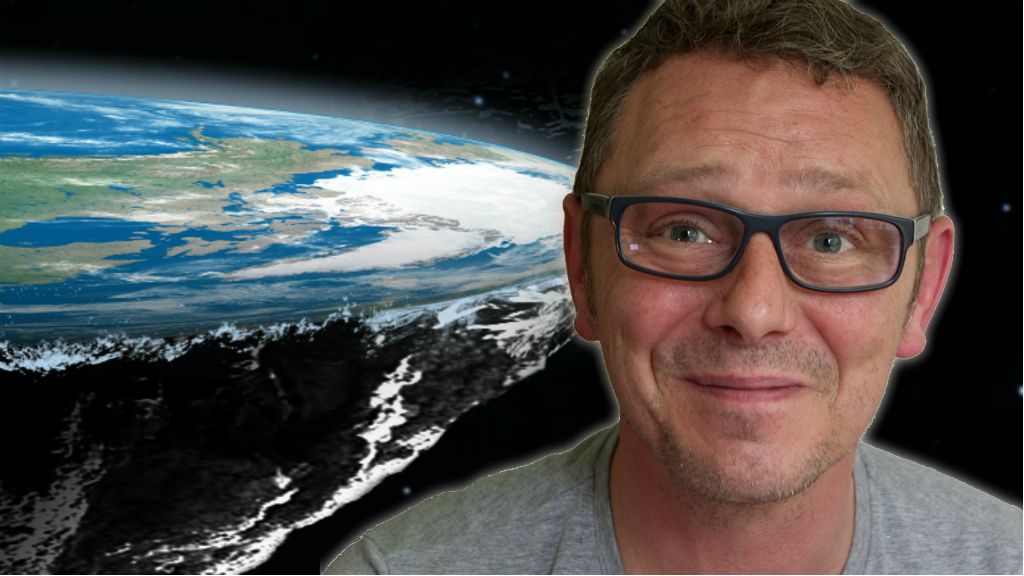 British flat Earther Dave against the backdrop of a flat Earth model.