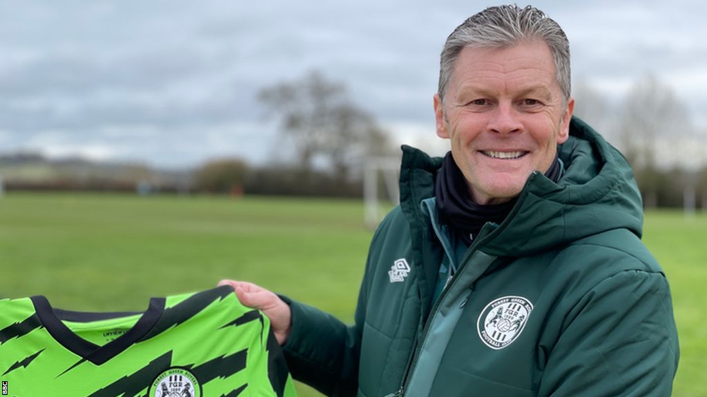 Steve Cotterill holds up a Forest Green jersey