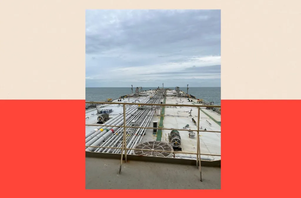 An image of the Gale ship, taken from a platform, looking towards the front of the tanker. There are railings in the foreground and see and sky visible