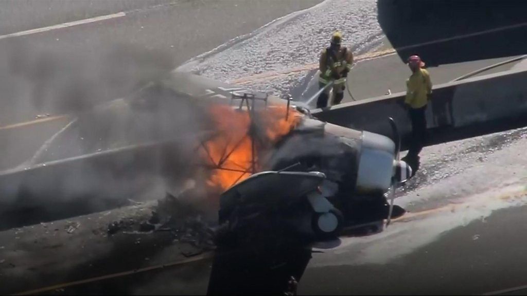 Plane in flames after crashing onto US motorway