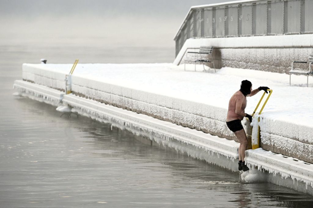 A man gets out from a swim in Helsinki, Finland, in weather of -15C.