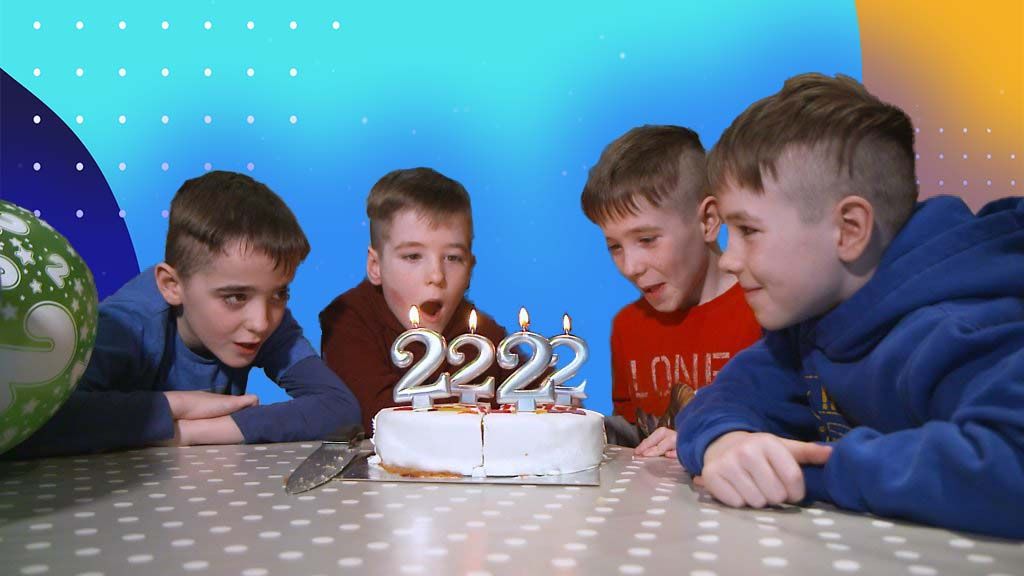 quadruplets-blow-out-candles-on-their-birthday-cake.