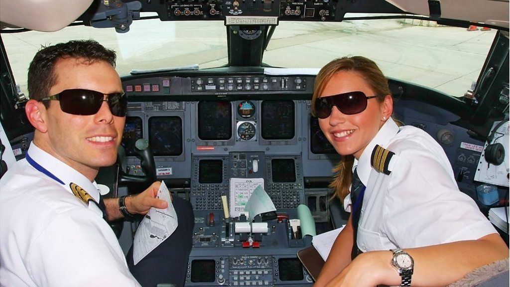 Young pilots flying in cockpit of commercial jet