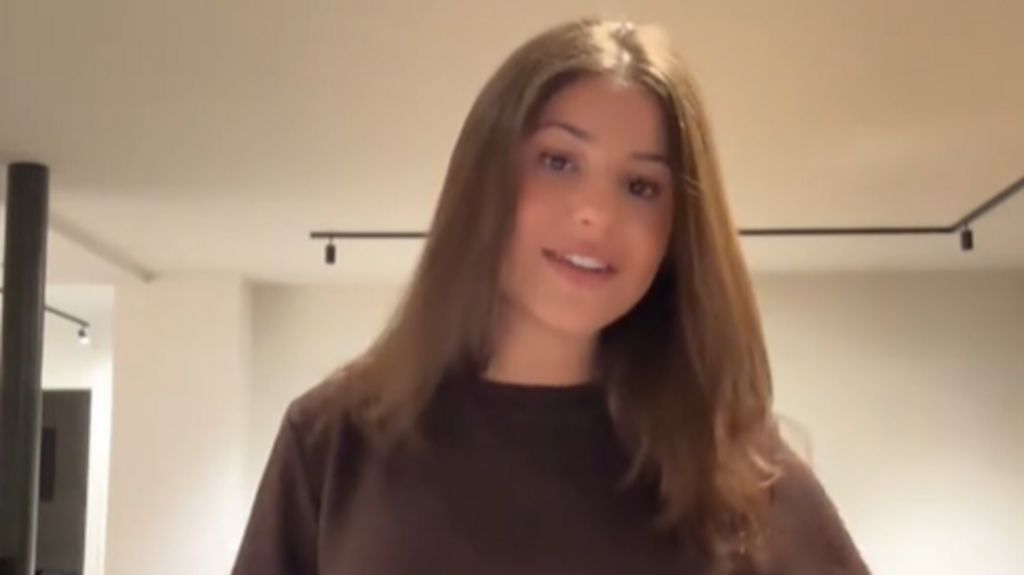 Charlotte Niddam poses in a brown t-shirt