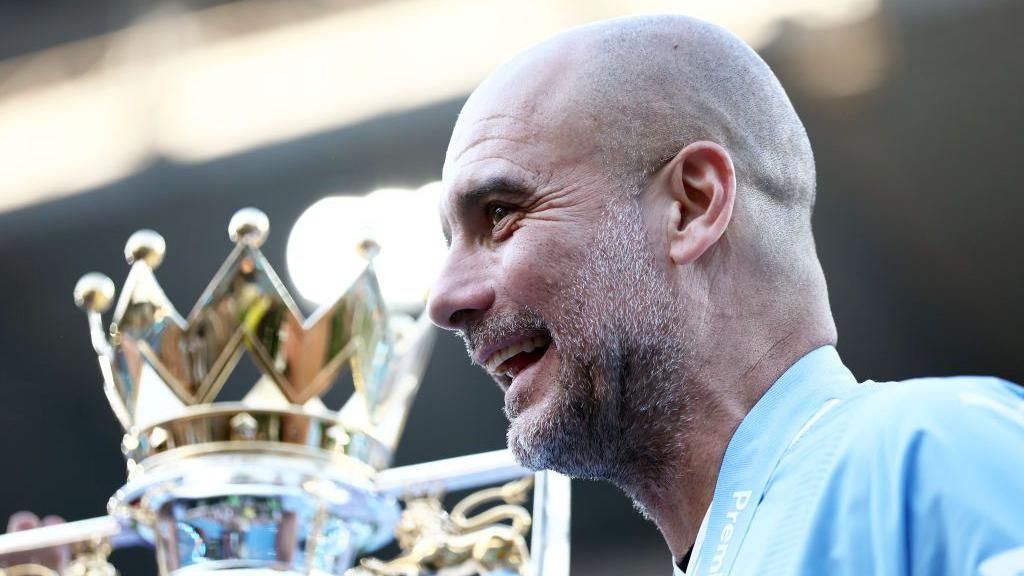 Manchester City manager Pep Guardiola with the Premier League trophy