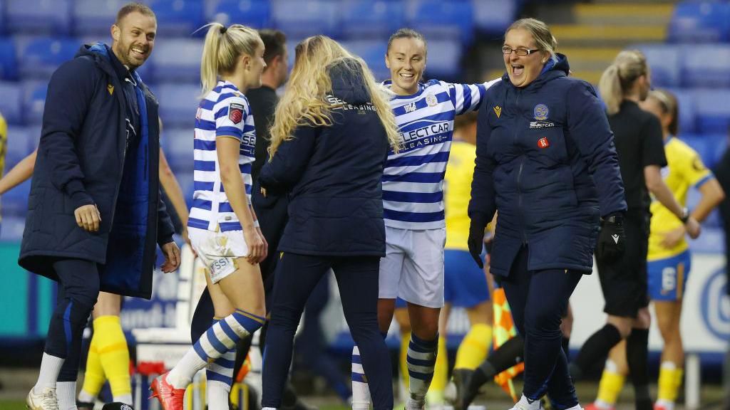 Kelly Chambers celebrates with Reading players after a match.
