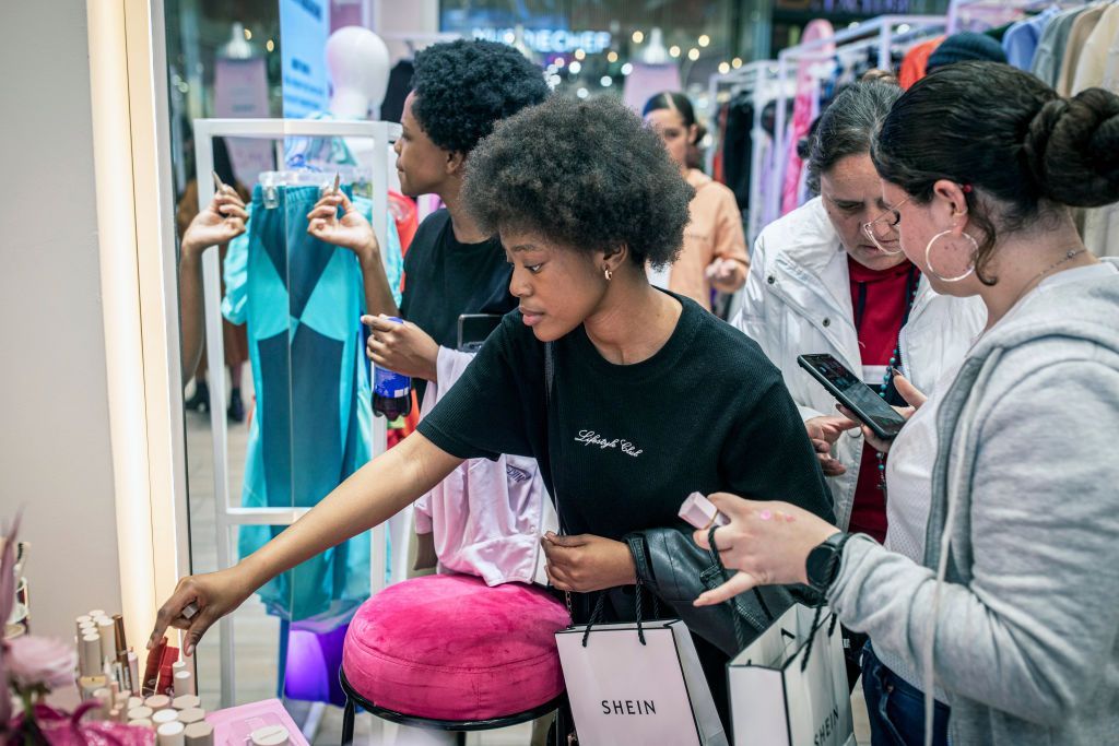 Customers try make-up at the Shein pop-up store in Mall of Africa on in Johannesburg, South Africa - August 2024