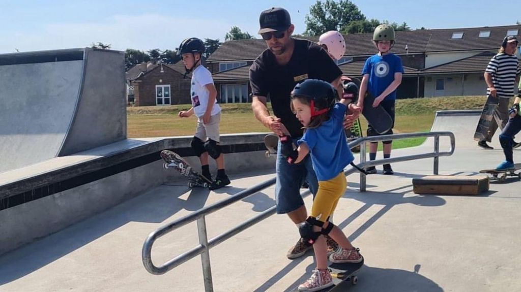 Children learning to skateboard