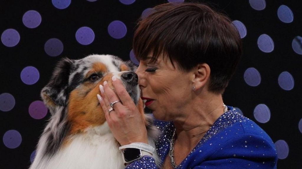  Owner Melanie Raymond kisses her dog, Viking