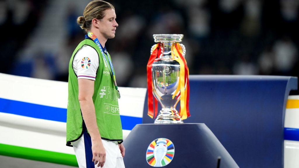 Conor Gallagher walks past the European Championship trophy after England's defeat to Spain in the 2024 final