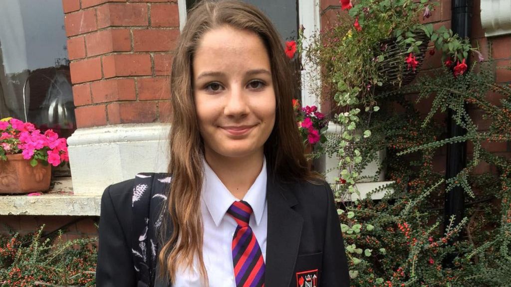 Molly Russell outside her house in school uniform, smiling