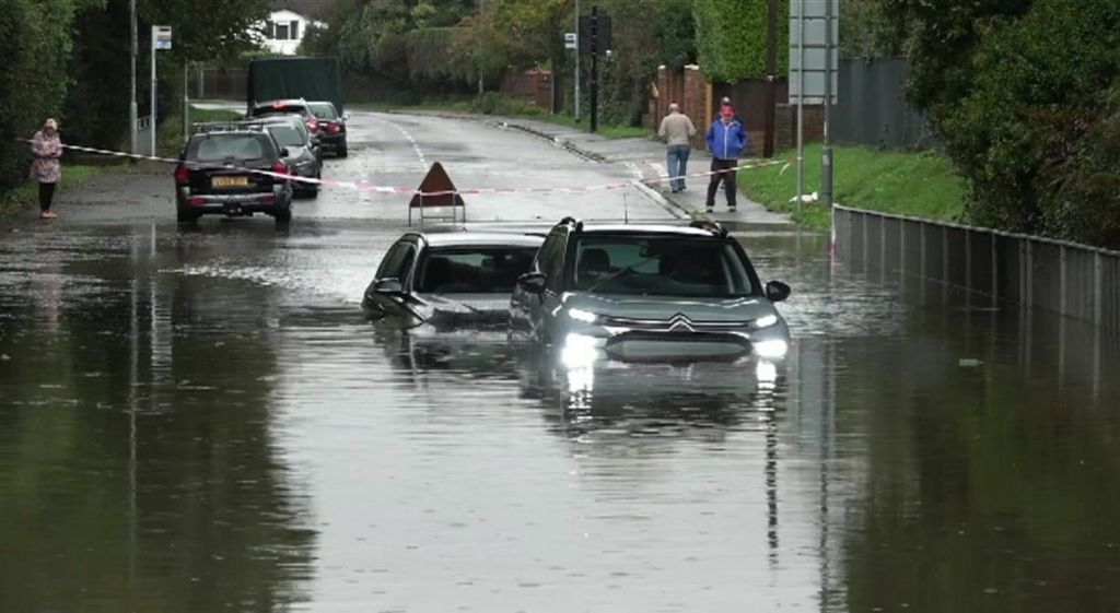 Two cars trapped in flood water