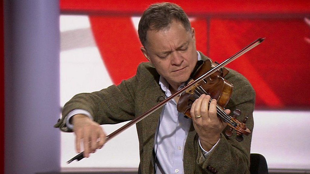 Stephen Morris playing his violin in the BBC News studio