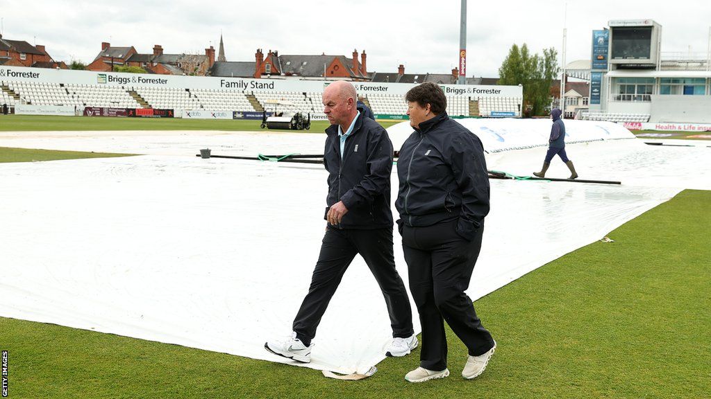 Umpires Graham Lloyd and Sue Redfern inspect the field at Wantage Road