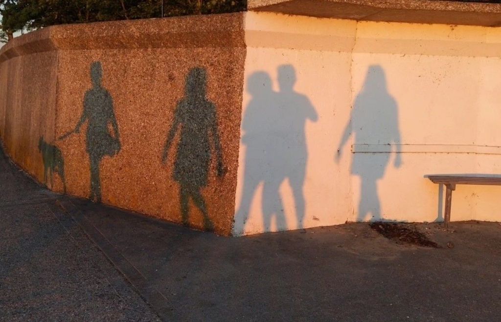 Shadows of people on a wall
