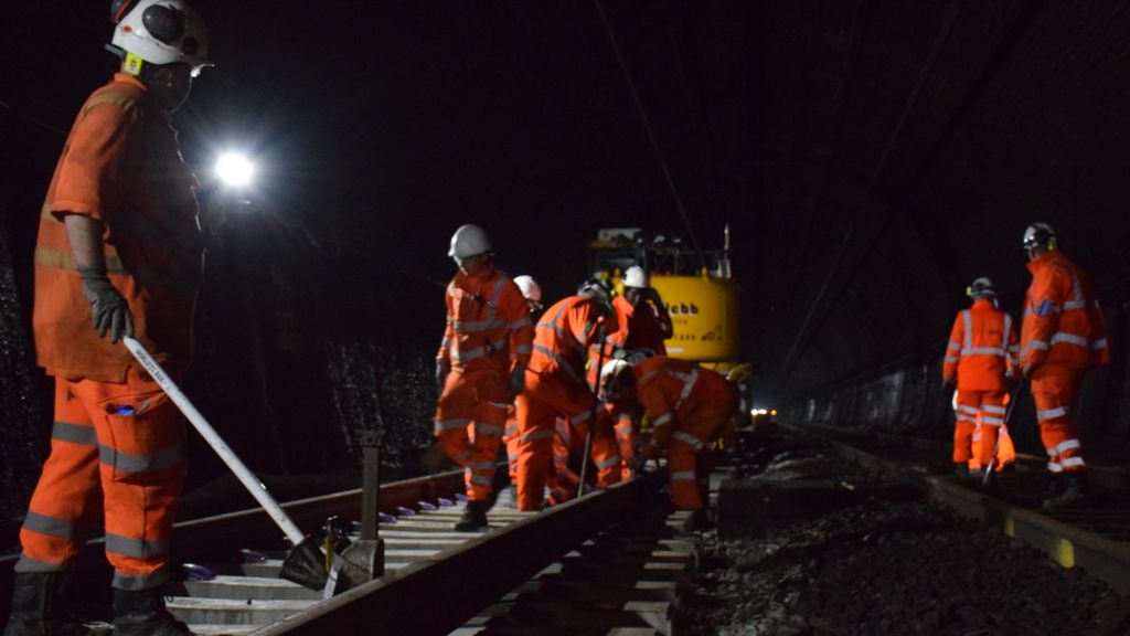 Workers in high-vis clothing fix the track in the Severn Tunnel