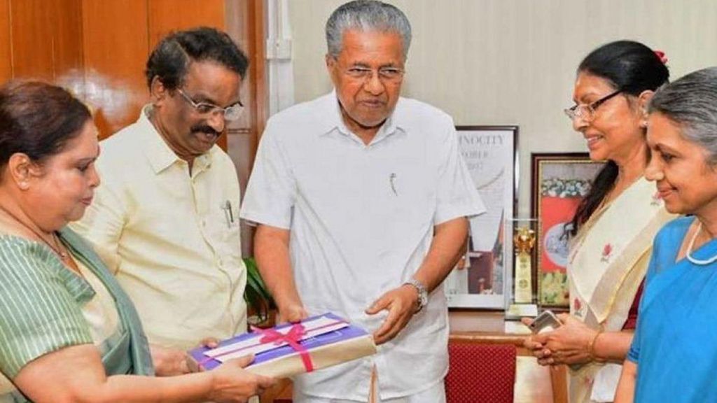 Members of the commission seen handing over a report tied up with pink ribbon to Kerala Chief Minister Pinarayi Vijayan