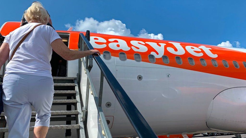 Woman boards EasyJet plane