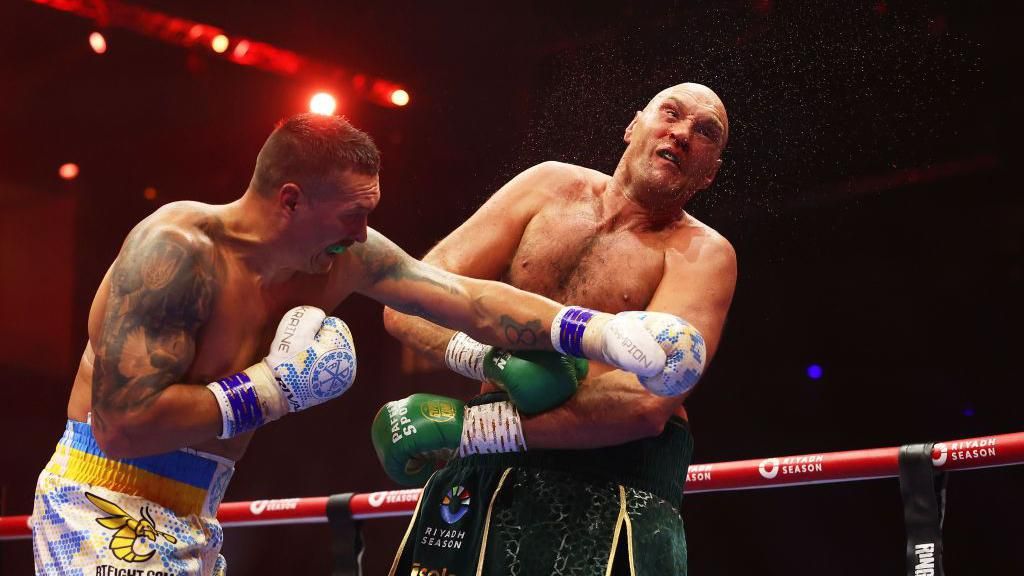 Tyson Fury falls backwards from a punch from Oleksandr Usyk