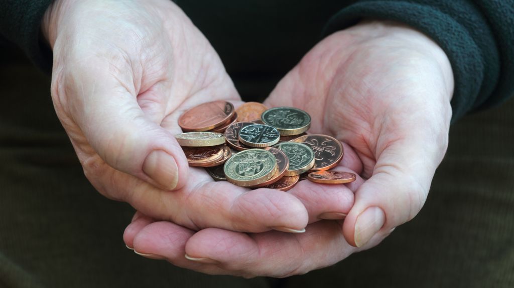 Man holding British coins