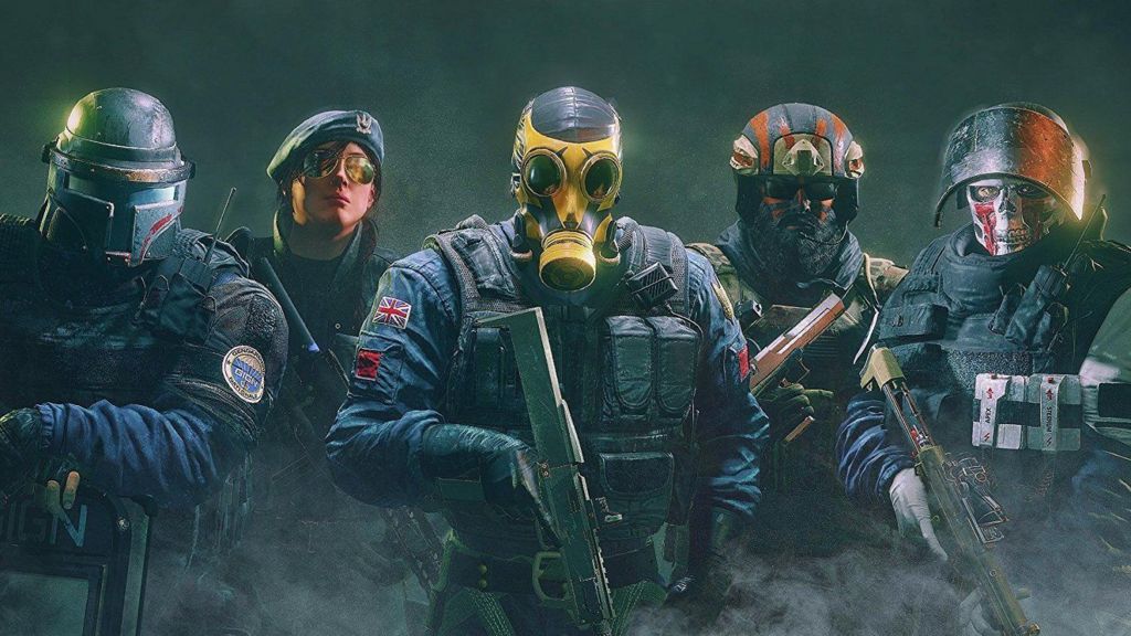 A promotional picture for Rainbow Six Siege featuring 5 soldiers looking into the camera from different militaries. The UK one is front and centre wearing a yellow gas mask and carrying a shotgun. 