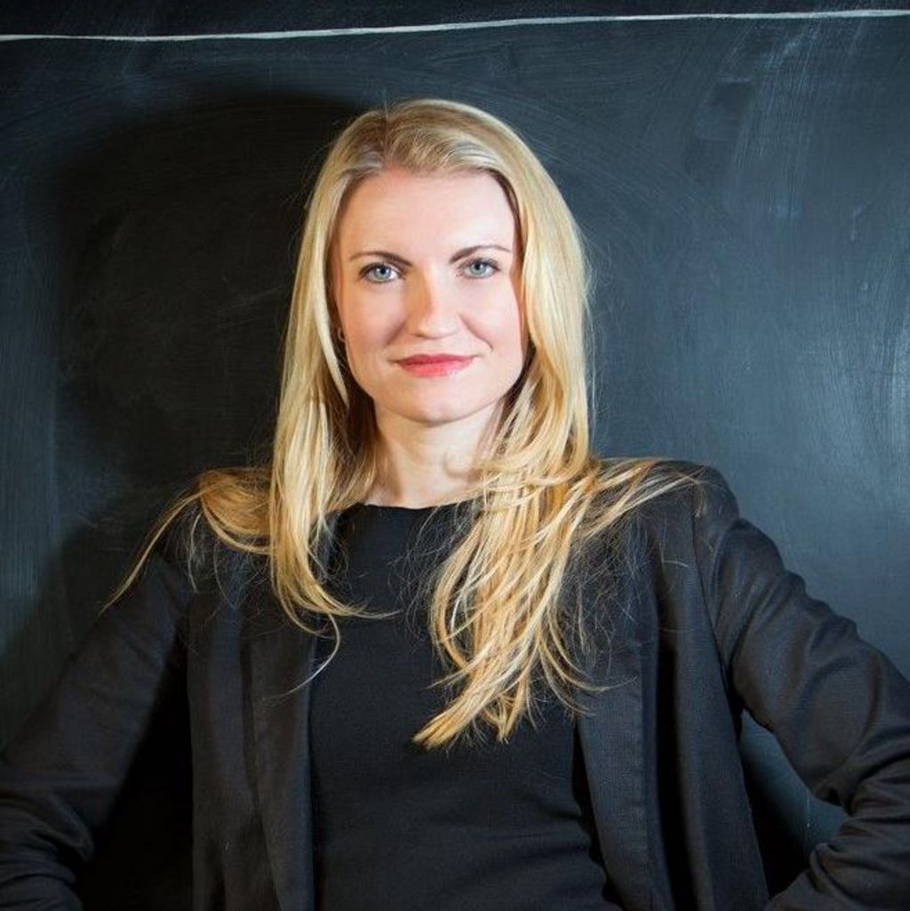 Kate, a blonde woman wearing a black top and blazer.