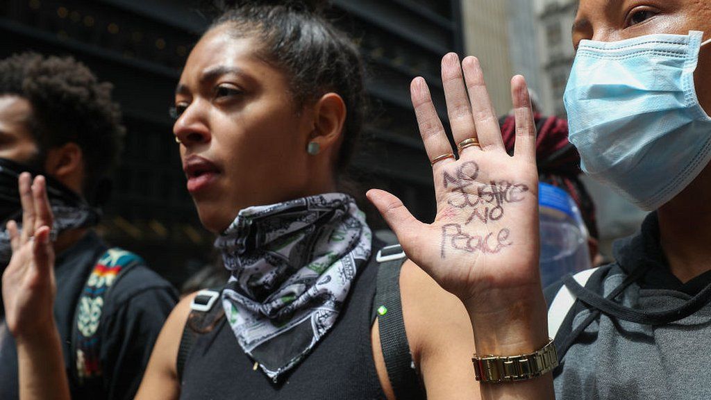 Woman in New York holding hands up as part of a protest