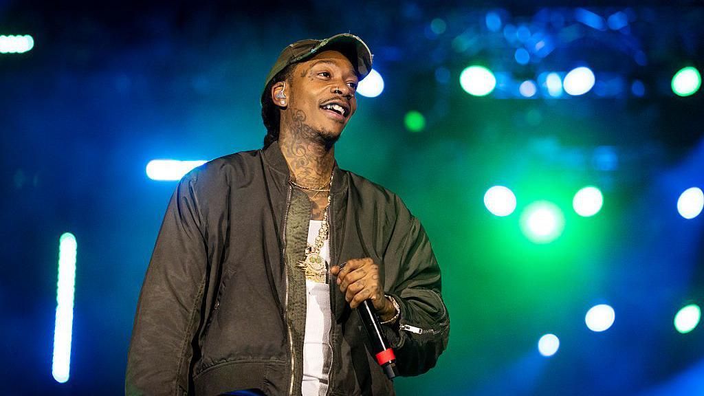Wiz Khalifa wears a vest and jacket with a big chain on stage at Loud Park in Mumbai