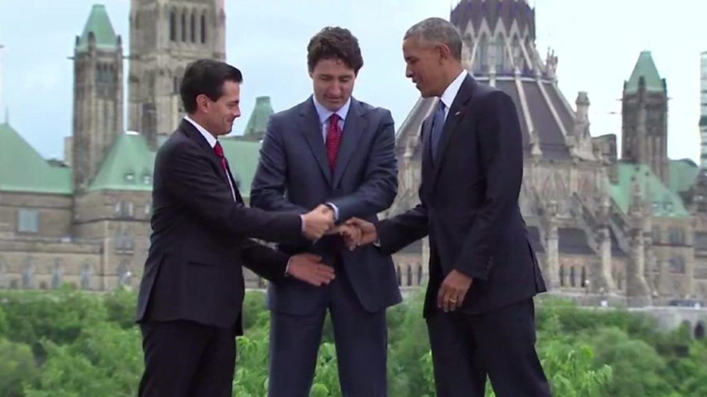 Handshake involving Canada's PM Justin Trudeau and former US President Barack Obama