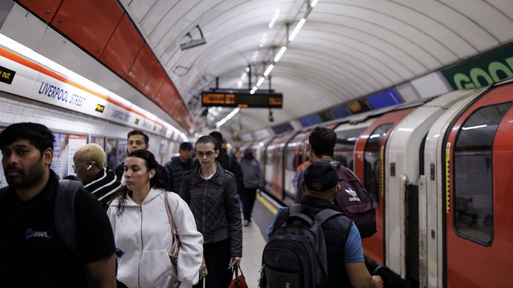 Commuters get off from a terminated tube service at Liverpool Street station during a 24-hour strike by London Underground tube drivers.
