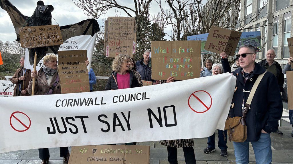 Protesters outside New County Hall holding placards