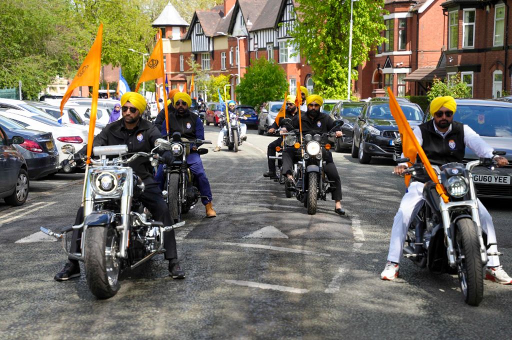 Men on motorbikes with Sikh flags