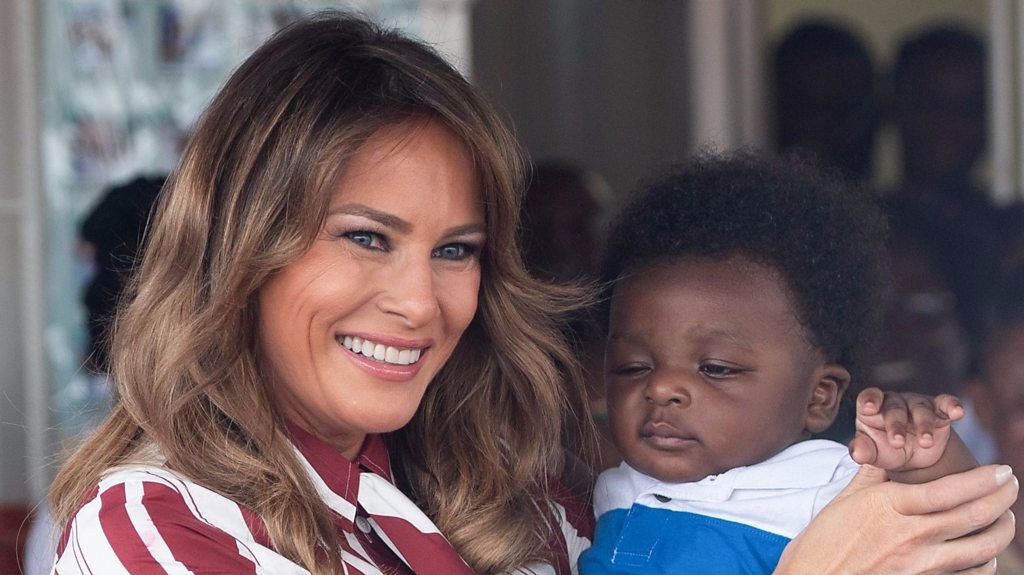 Melania Trump holds a baby in Accra, Ghana