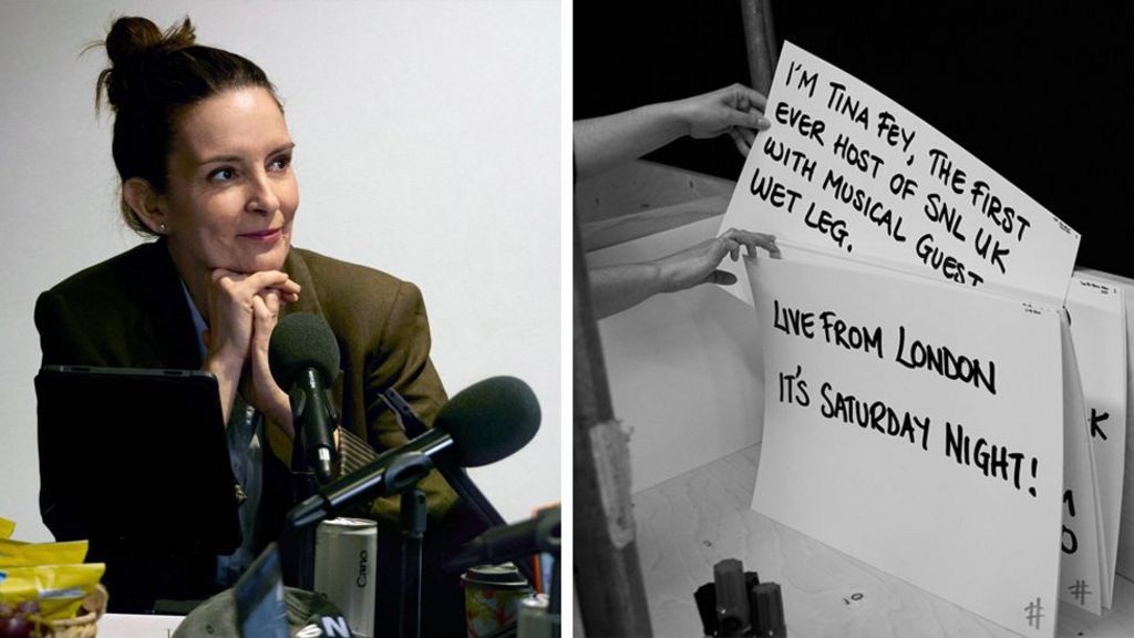 Picture of Tina Fey at a table read for SNL UK. She is smiling in a green blazer next to some microphones and an image of cue cards for Tin Fey being sorted backstage.