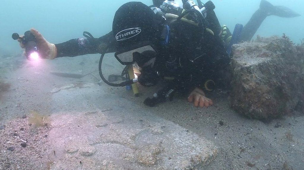 Diver viewing gravestone on The Mortar Wreck