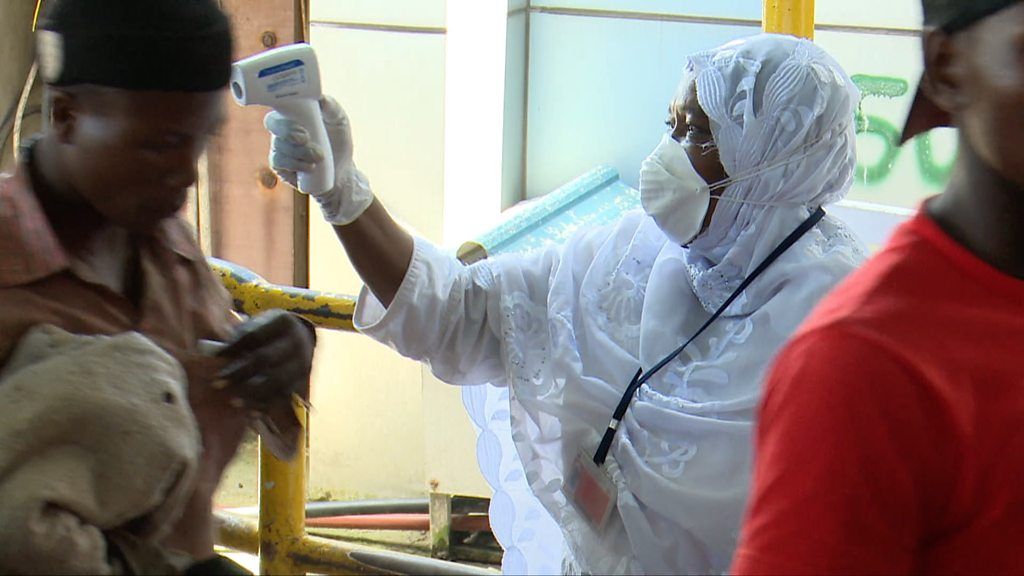 Health worker checking temperature