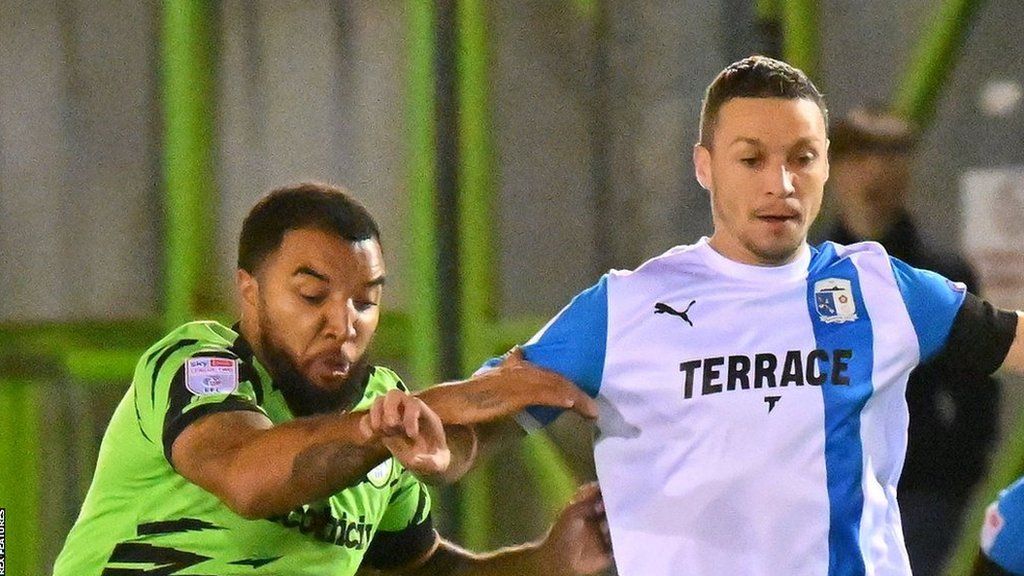Forest Green's Troy Deeney battles with James Chester of Barrow
