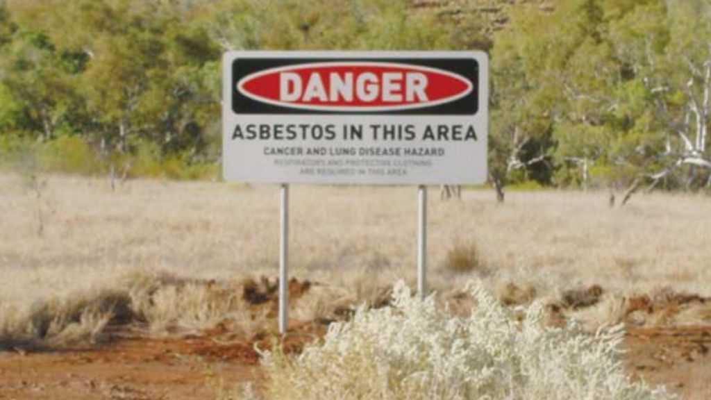 A warning sign around Wittenoom which reads: Danger. Asbestos in this area. Cancer and Lung disease hazard