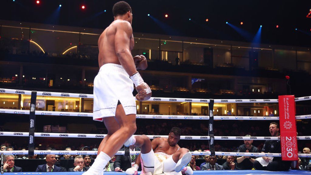 Anthony Joshua stands over Francis Ngannou