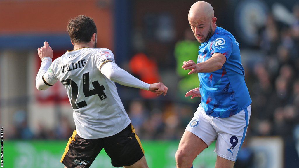 Aaron Wildig of Newport County and Paddy Madden of Stockport County