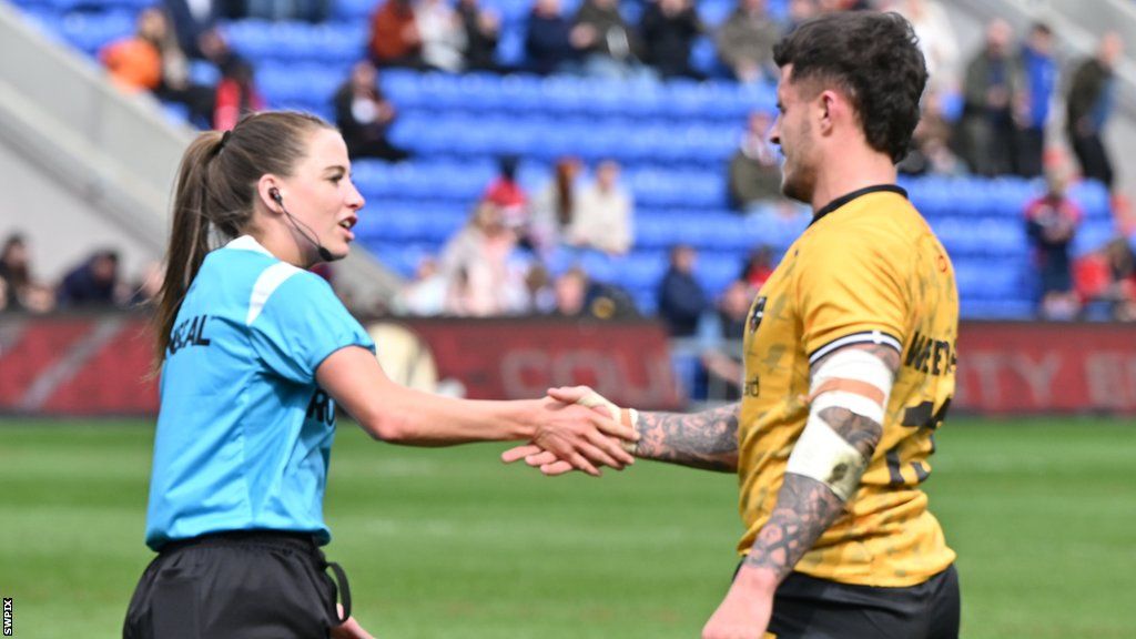 Tara Jones shaking hands with a player