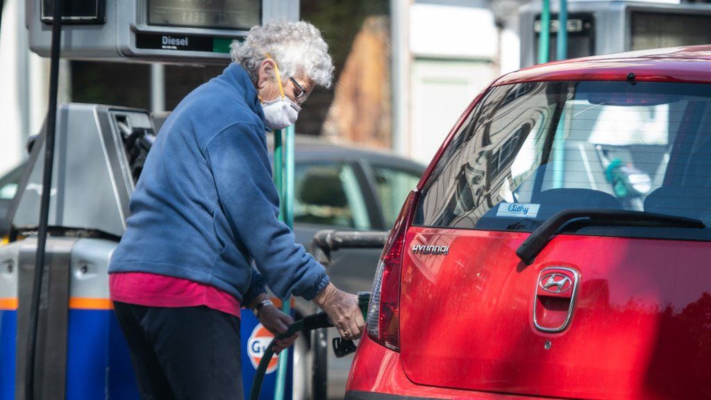 Woman filling up car with petrol