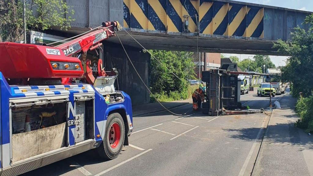 Image of a railway bridge on High Road, Vange, in Basildon. A lorry has been overturned
